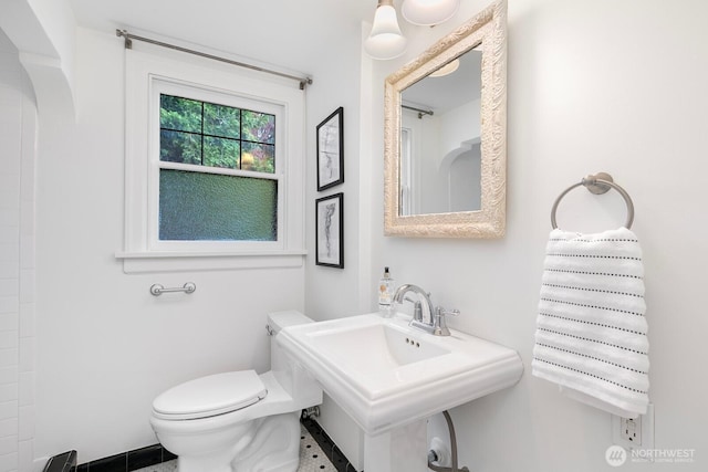 bathroom with toilet and a sink