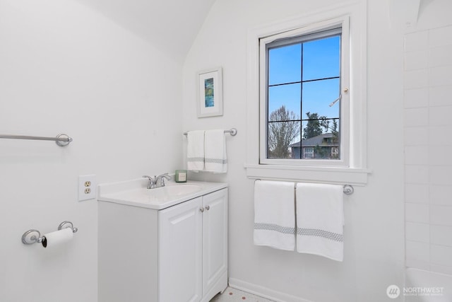 bathroom with lofted ceiling and vanity