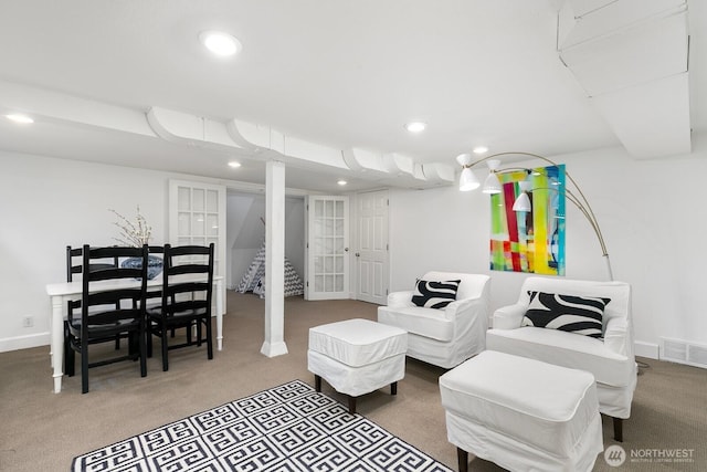 carpeted living area with recessed lighting, visible vents, and baseboards