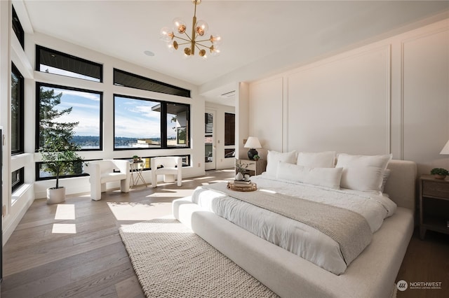 bedroom featuring hardwood / wood-style floors and a notable chandelier