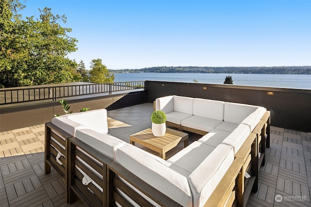 view of patio / terrace featuring an outdoor living space, a balcony, and a water view