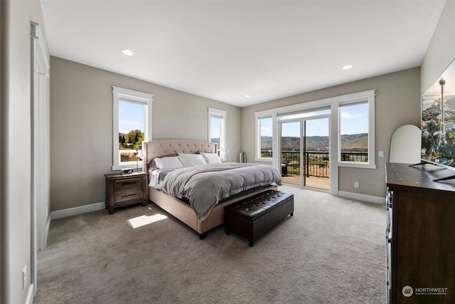 carpeted bedroom featuring multiple windows and access to exterior