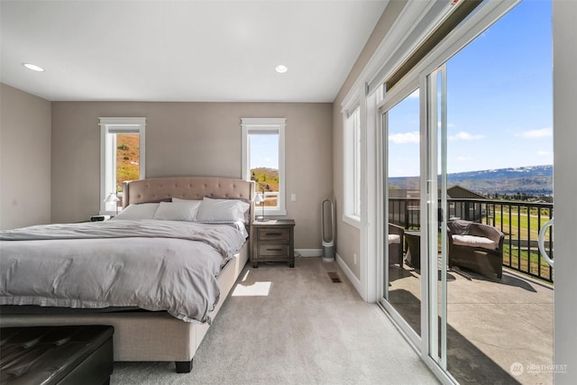 carpeted bedroom featuring access to exterior and multiple windows