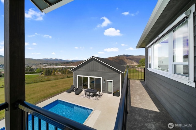 11 Holcomb Dr, East Wenatchee, WA 98802 - back of property featuring a mountain view, an outdoor pool, a lawn, and a patio area
