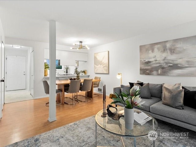 living room with hardwood / wood-style floors and an inviting chandelier