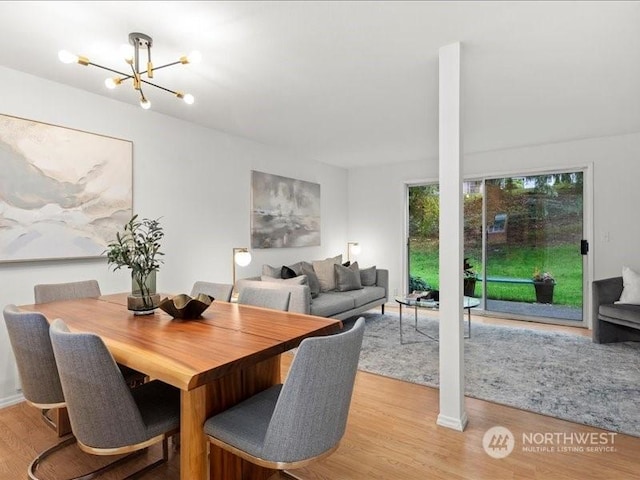 dining area with a notable chandelier and light wood-type flooring