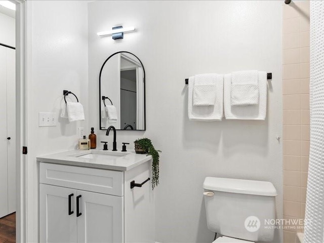 bathroom featuring vanity and toilet