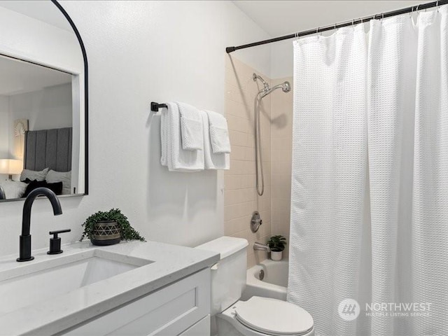 full bathroom featuring vanity, shower / tub combo, and toilet