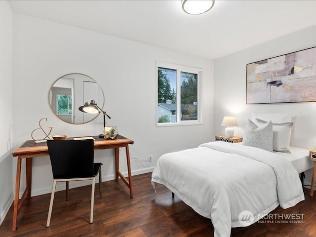 bedroom with dark wood-type flooring