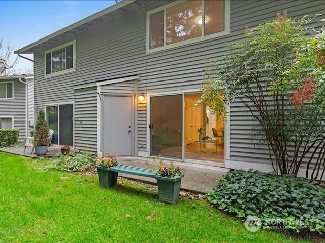 rear view of property featuring a yard