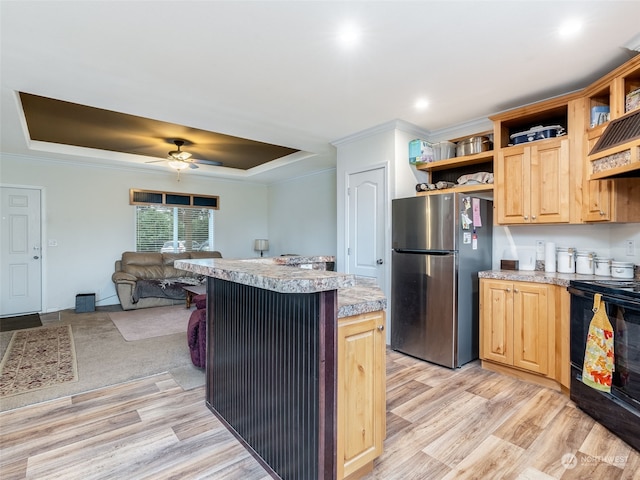 kitchen featuring stainless steel fridge, black stove, ceiling fan, light hardwood / wood-style floors, and a kitchen island