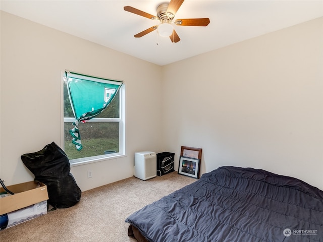 bedroom with ceiling fan and light carpet