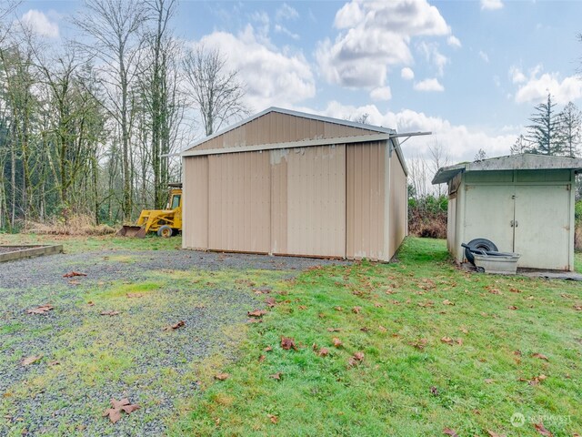 view of outbuilding featuring a yard