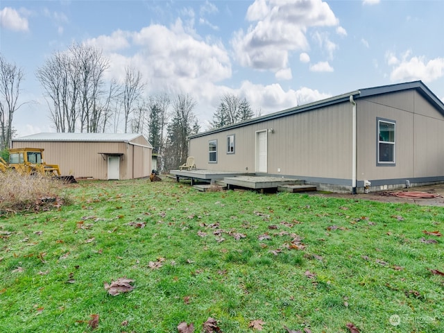 view of home's exterior featuring a yard and an outdoor structure