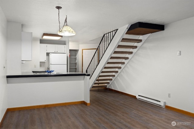 1305 W Clearbrook Unit 7, Bellingham, WA 98229 - kitchen featuring freestanding refrigerator, a baseboard radiator, wood finished floors, dark countertops, and decorative light fixtures