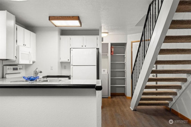 1305 W Clearbrook Unit 7, Bellingham, WA 98229 - kitchen featuring white appliances, a peninsula, wood finished floors, and white cabinets