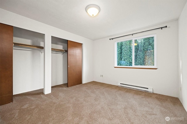 1305 W Clearbrook Unit 7, Bellingham, WA 98229 - unfurnished bedroom with a baseboard radiator, two closets, and carpet flooring