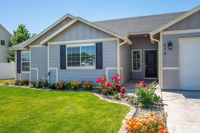 view of front facade featuring a garage and a front yard