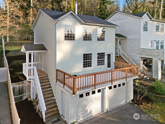 rear view of property featuring a garage