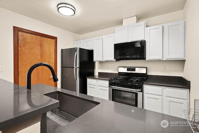 kitchen with white cabinets, appliances with stainless steel finishes, and sink