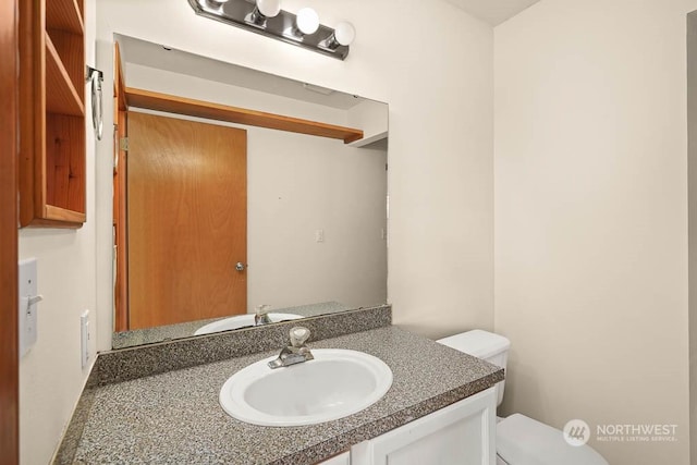 bathroom with vanity and toilet