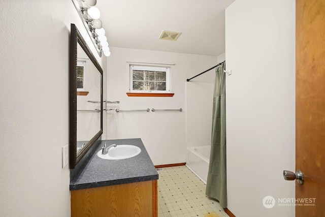 bathroom featuring vanity and shower / tub combo with curtain