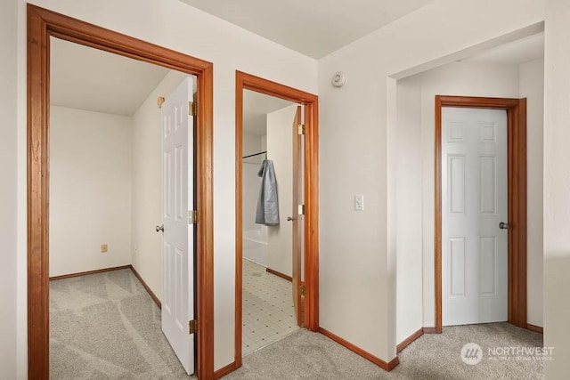 hallway with light colored carpet