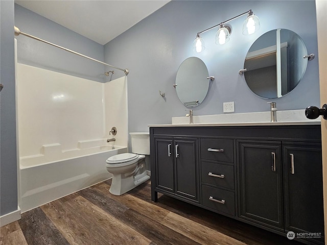 full bathroom with shower / bathing tub combination, vanity, hardwood / wood-style flooring, and toilet