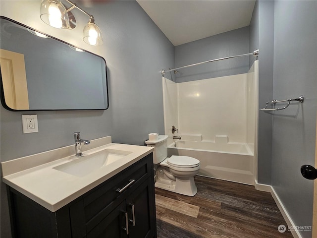 full bathroom featuring wood-type flooring, vanity, toilet, and tub / shower combination