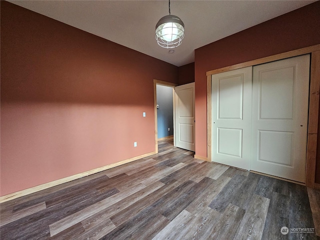 unfurnished bedroom with a closet and wood-type flooring