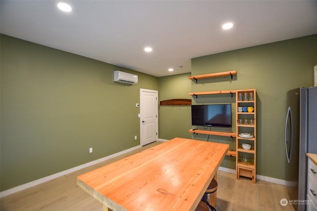 office area featuring a wall unit AC and light hardwood / wood-style floors