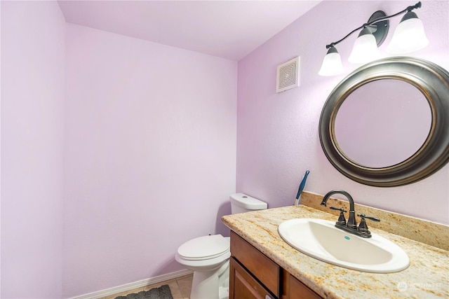 bathroom with tile patterned floors, vanity, and toilet