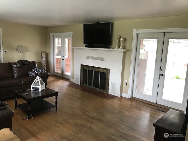 living room with french doors and hardwood / wood-style floors