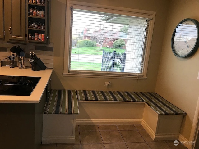 tiled dining space with a healthy amount of sunlight