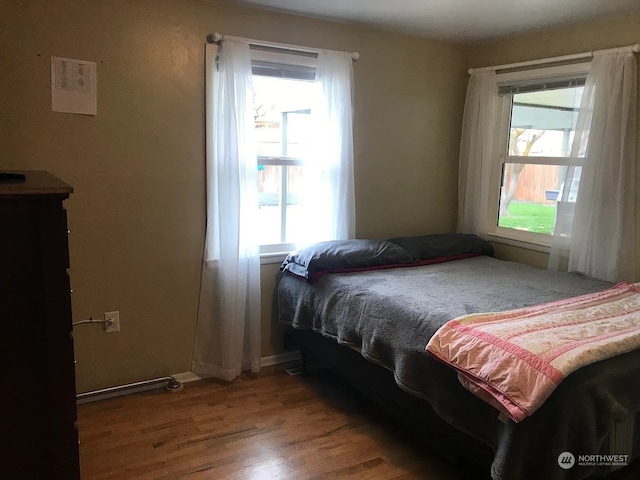 bedroom featuring hardwood / wood-style flooring and multiple windows