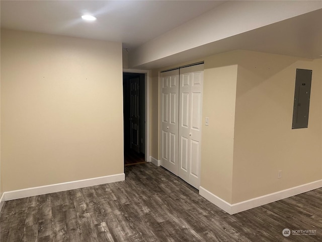 interior space featuring dark hardwood / wood-style flooring, electric panel, and a closet