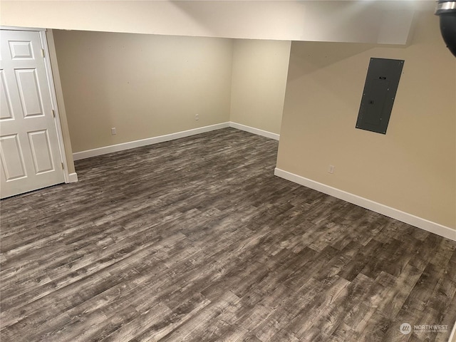 basement featuring dark wood-type flooring and electric panel