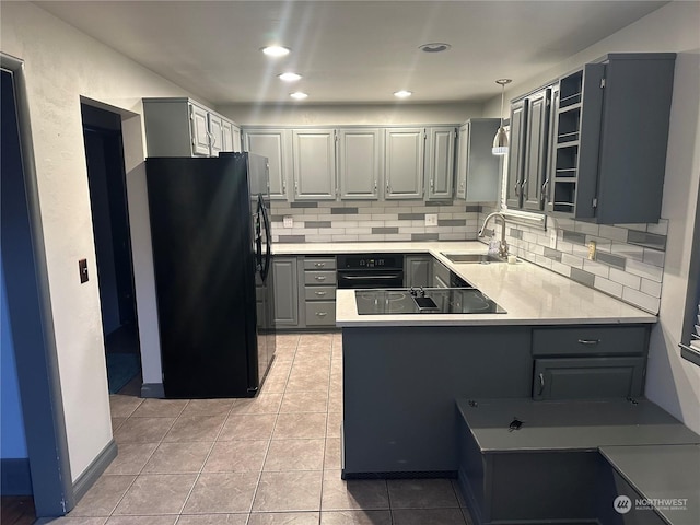 kitchen with gray cabinets, pendant lighting, black appliances, and sink