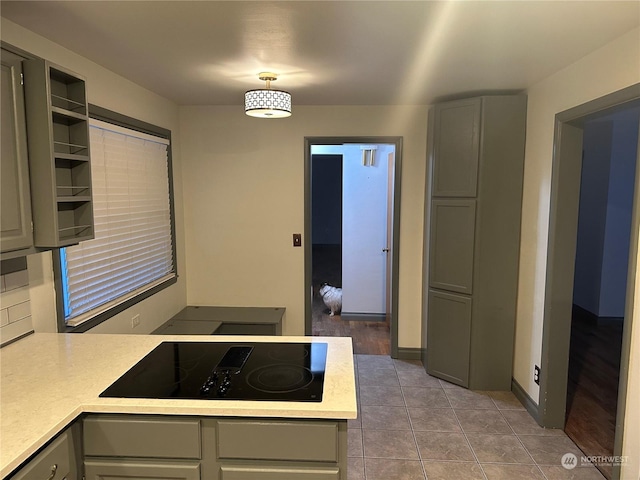 319 N 46th Ave, Yakima, WA 98908 - kitchen with black electric stovetop, gray cabinets, light countertops, and a peninsula