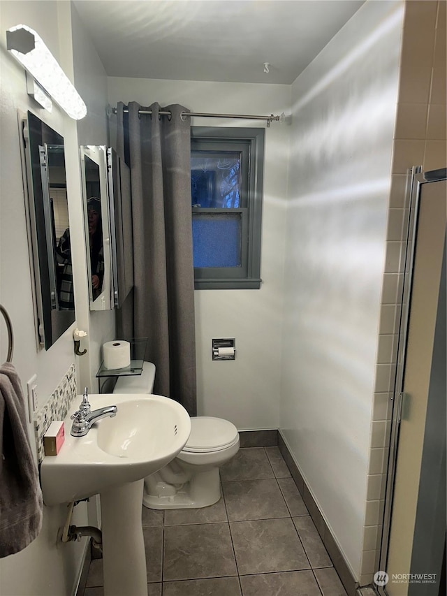 bathroom featuring tile patterned floors and toilet