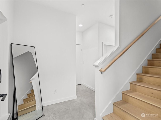 stairway with concrete floors