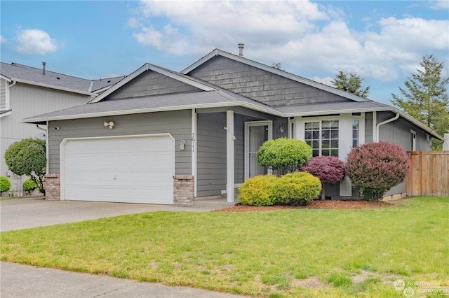 view of front of home featuring a garage and a front lawn