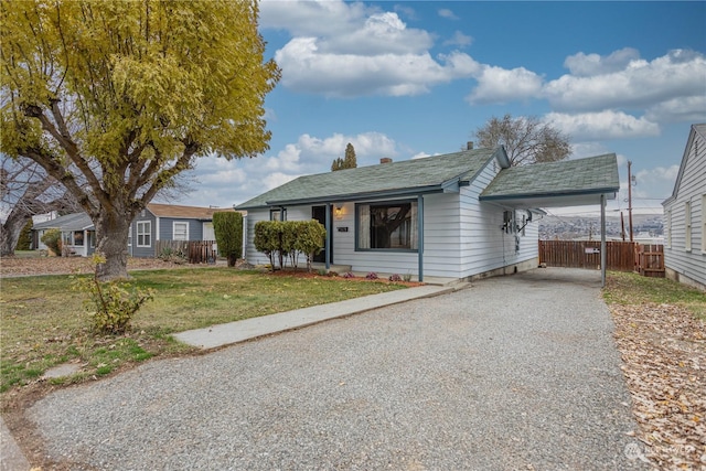 view of front facade with a carport and a front lawn