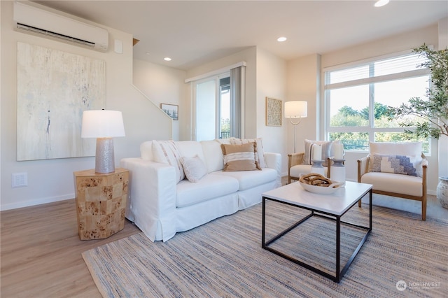 living room with hardwood / wood-style flooring and a wall mounted air conditioner