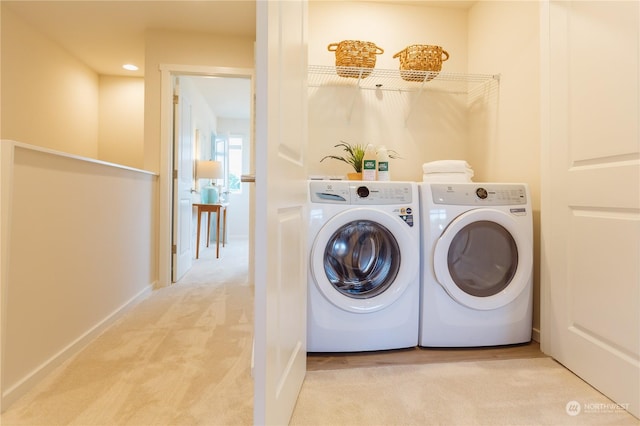 laundry room featuring washing machine and dryer and light carpet