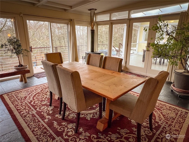 7251 Oak Bay Rd, Port Ludlow, WA 98365 - dining space featuring beam ceiling, coffered ceiling, and stone tile floors