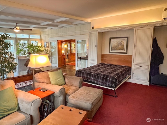 bedroom with ceiling fan, beam ceiling, and an AC wall unit