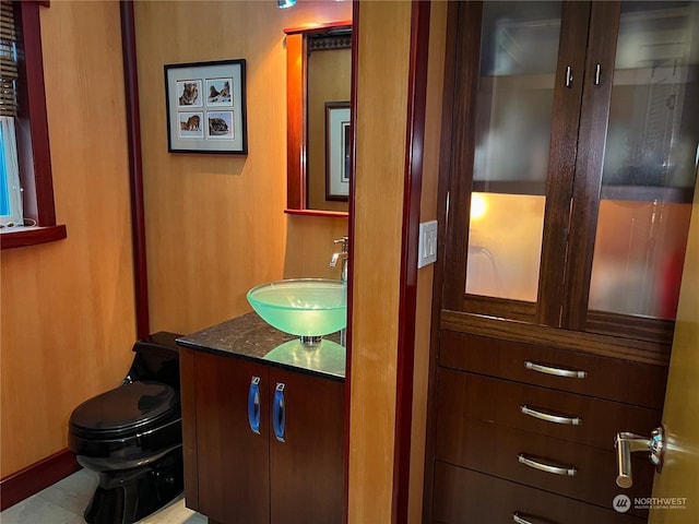 bathroom featuring tile patterned floors, vanity, and toilet