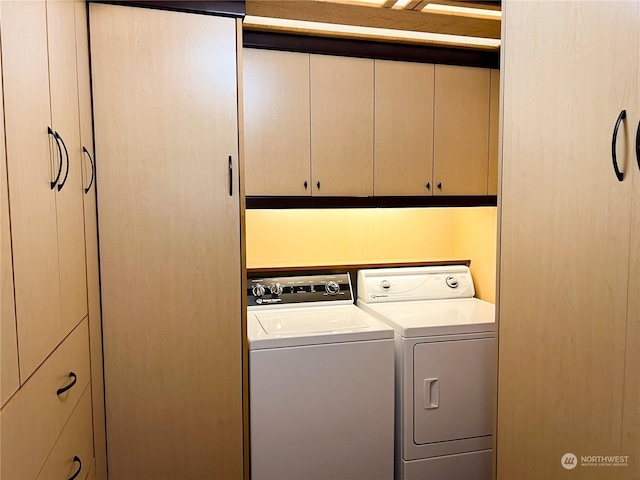 laundry room featuring cabinets and separate washer and dryer