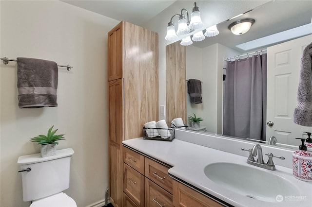 bathroom featuring vanity, toilet, and walk in shower